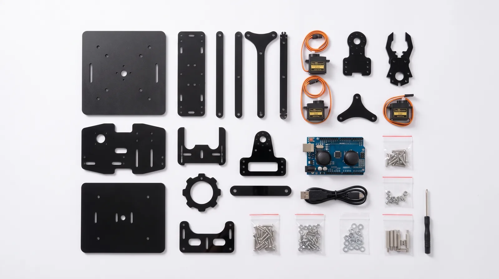 Every part of the kit laid out: laser-cut black acrylic plates, four servos, controller board, fasteners and tools