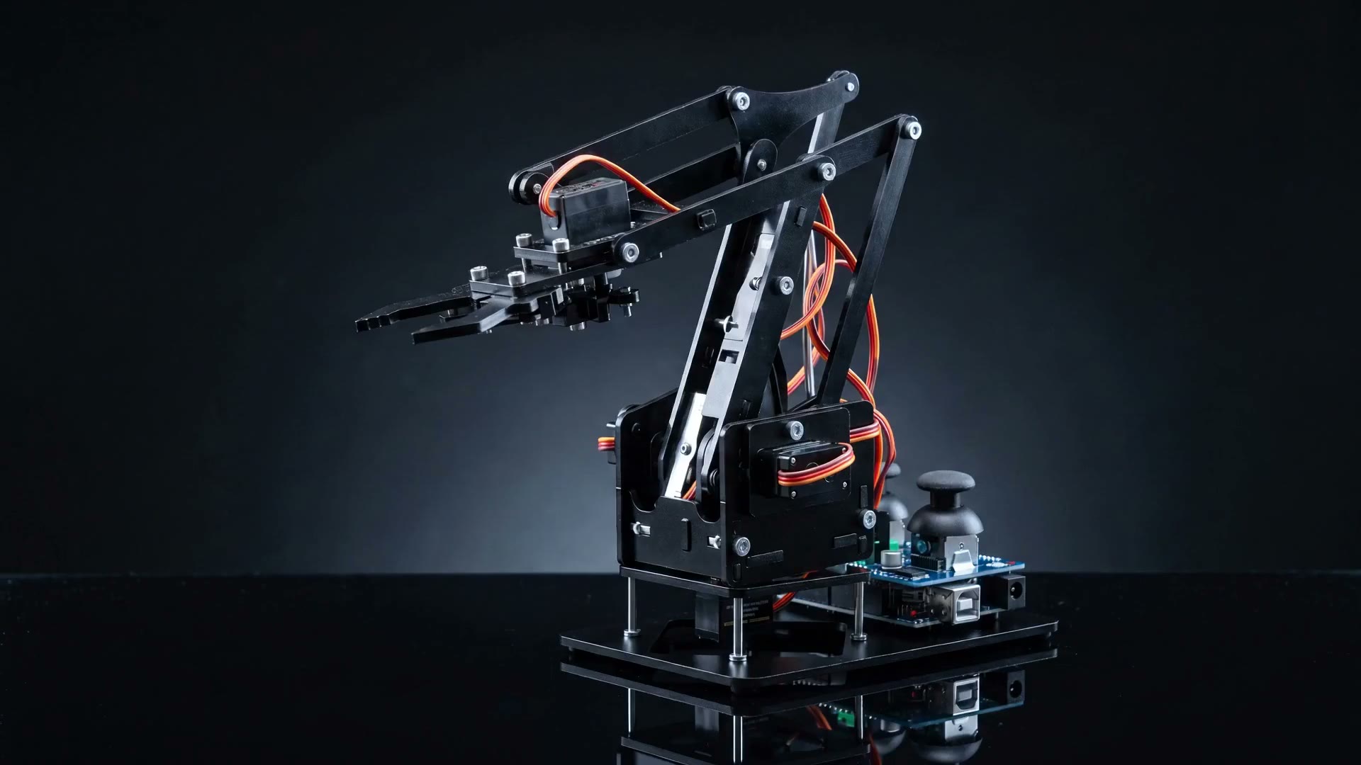 The RA01 arm mid-explosion: plates, servos and linkages separated in space on a dark background